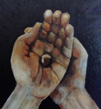 Hands holding a hazel nut